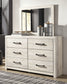 Cambeck King Upholstered Panel Bed with Mirrored Dresser